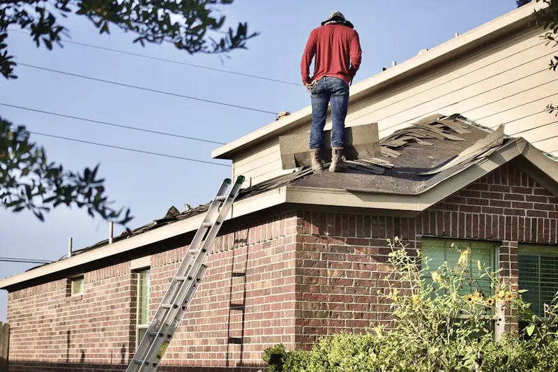 Professional roofer working on a residential roof in Vista Park